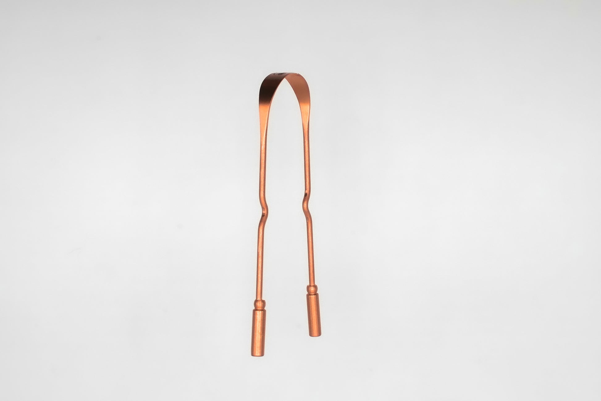 Side view of copper tongue scraper